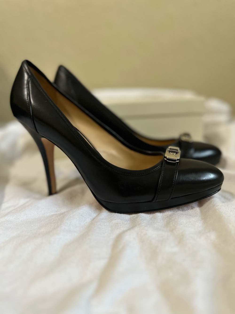 Coach black leather platform pumps with the signature Coach turn-lock hardware a